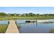 Wooden dock on the water overlooking grassy land and waterfront homes under a clear blue sky at 314 Commonwealth Rd, Mount Pleasant, SC 29466