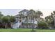 Charming coastal home with elevated stairs, mature landscaping, and a welcoming front porch at 314 Commonwealth Rd, Mount Pleasant, SC 29466
