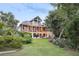 Beautiful home exterior showcasing lush landscaping, a spacious porch, and outdoor entertainment space at 314 Commonwealth Rd, Mount Pleasant, SC 29466