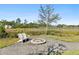 Enjoy your outdoor evenings relaxing near the firepit and adirondack chairs, surrounded by trees at 314 Commonwealth Rd, Mount Pleasant, SC 29466