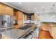 Open-concept kitchen with granite countertops, stainless steel appliances, and wooden cabinets at 314 Commonwealth Rd, Mount Pleasant, SC 29466