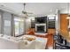 Open living room features hardwood floors, a fireplace, and access to an outdoor balcony at 314 Commonwealth Rd, Mount Pleasant, SC 29466