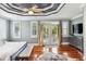 Bright main bedroom featuring french doors to a balcony, wood floors, and stylish furnishings at 314 Commonwealth Rd, Mount Pleasant, SC 29466