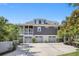 Home featuring a three car garage, covered porch, and well maintained landscaping at 314 Commonwealth Rd, Mount Pleasant, SC 29466