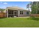 View of the backyard featuring a screened porch and fenced perimeter at 318 Bering Ln, Summerville, SC 29486