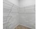 A walk-in closet with white wire shelving and neutral carpeting at 318 Bering Ln, Summerville, SC 29486