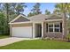 Charming exterior with brick facade, two-car garage, well-maintained lawn, and manicured landscaping at 318 Bering Ln, Summerville, SC 29486