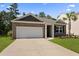 Attractive home exterior with brick, two-car garage, well-manicured lawn, and palm tree at 318 Bering Ln, Summerville, SC 29486