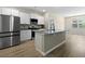 Bright kitchen with granite countertops, stainless steel appliances, and an eat-in island at 318 Bering Ln, Summerville, SC 29486