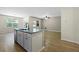 Well-lit kitchen featuring a central island, stainless steel dishwasher and hardwood floors at 318 Bering Ln, Summerville, SC 29486