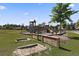 Community playground with wooden structures, slides, and sandboxes in a grassy area at 318 Bering Ln, Summerville, SC 29486