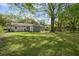 Spacious backyard with lush green grass and mature trees, perfect for outdoor activities at 323 Millcreek Dr, Charleston, SC 29407