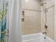 Tiled bathtub and shower combo with updated fixtures and a neutral color scheme at 323 Millcreek Dr, Charleston, SC 29407