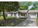 Well-maintained home featuring a charming brick exterior, attached garage and a spacious driveway at 323 Millcreek Dr, Charleston, SC 29407