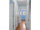 Inviting hallway with hardwood floors and white doors, bathed in natural light at 323 Millcreek Dr, Charleston, SC 29407