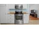 Modern kitchen featuring stainless steel oven, microwave, granite countertops, and white cabinetry at 323 Millcreek Dr, Charleston, SC 29407