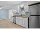 Updated kitchen with stainless steel appliances, granite countertops, and white cabinetry at 323 Millcreek Dr, Charleston, SC 29407