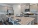 Bright kitchen with granite countertops, stainless steel appliances, and a large island with seating at 323 Willow Run Dr, Summerville, SC 29486