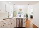 Bright kitchen with white cabinetry, stainless steel appliances, and open layout to dining area at 350 Arlington Dr, Charleston, SC 29414
