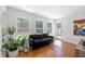 Sunlit living room featuring large windows with views of the backyard and wood flooring at 350 Arlington Dr, Charleston, SC 29414