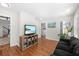 Comfortable living room showcasing a TV, wood floors, and access to other parts of the house at 350 Arlington Dr, Charleston, SC 29414
