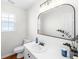 A well-lit powder room features a sleek mirror, white vanity, and modern fixtures at 350 Arlington Dr, Charleston, SC 29414