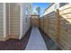 Walkway to back gate, enclosed with wooden fence, adds security and privacy to side yard at 350 Arlington Dr, Charleston, SC 29414