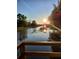 Scenic waterfront view with sunlight reflecting off the calm water and boathouse at 350 Arlington Dr, Charleston, SC 29414