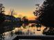 Beautiful sunset view over the water, reflecting the sky's vibrant colors and nearby houses at 350 Arlington Dr, Charleston, SC 29414