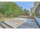 Large wooden deck with dining table, seating, and a view of the fenced backyard at 3661 Locklear Ln, Mount Pleasant, SC 29466