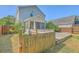 Backyard view featuring a wooden deck, fence, and a peek at the house and screened in porch at 3661 Locklear Ln, Mount Pleasant, SC 29466