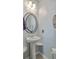 Small bathroom with pedestal sink and decorative mirror at 3661 Locklear Ln, Mount Pleasant, SC 29466