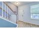 Bright entryway featuring wood-look tile flooring, a staircase, and a coat rack at 3661 Locklear Ln, Mount Pleasant, SC 29466