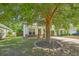 Charming single-Gathering home with tidy landscaping, a red door, and a healthy shade tree at 3661 Locklear Ln, Mount Pleasant, SC 29466