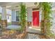 Welcoming covered porch with stone columns and a bright red front door at 3661 Locklear Ln, Mount Pleasant, SC 29466