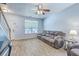 Comfortable living room featuring wood-look tile floors and a plush gray reclining sofa at 3661 Locklear Ln, Mount Pleasant, SC 29466