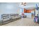 Open living room featuring wood-look tile, a plush gray sofa, and a ceiling fan at 3661 Locklear Ln, Mount Pleasant, SC 29466