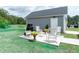 Well-manicured backyard patio with rocking chairs and an outdoor grill, ideal for gatherings and relaxation at 397 Woodgate Way, Summerville, SC 29485
