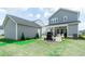 Expansive backyard with a patio, grill, and well-maintained lawn, perfect for outdoor activities and relaxation at 397 Woodgate Way, Summerville, SC 29485
