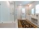 Modern bathroom with a glass-enclosed shower, white subway tile, and double vanity at 397 Woodgate Way, Summerville, SC 29485