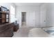 Light-filled bedroom with a bed, dresser, and an adjacent ensuite bathroom at 397 Woodgate Way, Summerville, SC 29485