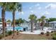 Resort-style community pool with lounge chairs and palm trees, perfect for relaxation at 397 Woodgate Way, Summerville, SC 29485