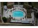 Aerial view of a large community pool with lounge chairs, umbrellas, and palm trees offering a resort-like experience at 397 Woodgate Way, Summerville, SC 29485