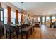Elegant dining room with a modern chandelier, large table, and warm, inviting atmosphere at 397 Woodgate Way, Summerville, SC 29485