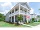 Charming two-story home featuring a spacious porch, landscaped yard, and inviting curb appeal at 397 Woodgate Way, Summerville, SC 29485