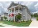Charming two-story home featuring a spacious porch, landscaped yard, and inviting curb appeal at 397 Woodgate Way, Summerville, SC 29485