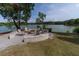 Relaxing lakeside fire pit area with Adirondack chairs, perfect for enjoying tranquil water views and outdoor gatherings at 397 Woodgate Way, Summerville, SC 29485