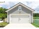 Detached two-car garage with a white door and a well-kept driveway and landscaping at 397 Woodgate Way, Summerville, SC 29485