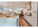 Bright, open kitchen featuring a large island, white cabinetry, stainless steel appliances, and modern lighting at 397 Woodgate Way, Summerville, SC 29485