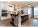 Modern kitchen features stainless steel appliances, white cabinets, and a cozy fireplace at 397 Woodgate Way, Summerville, SC 29485